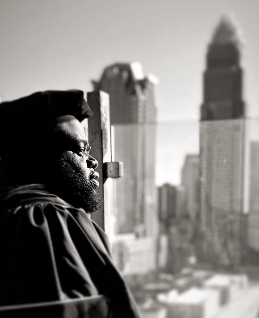 Dr. Kerry L. Shipman in doctoral regalia overlooking the Charlotte skyline